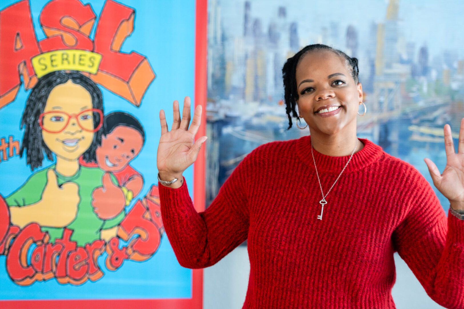 A woman in red sweater standing next to a wall.